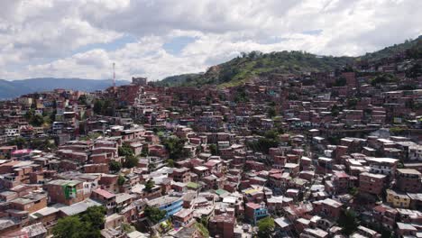 Aerial-view-of-Comuna-13,-showcasing-the-densely-packed-colorful-homes-nestled-in-the-Medellin-hills,-Colombia