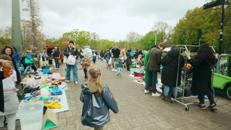 Girl-passing-by-Dutch-bicycles-enter-Amsterdam-Noorderpark-flea-market-garage-sale