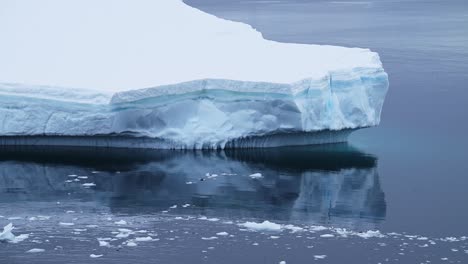 Blue-Iceberg-Floating-Close-Up-in-Ocean,-Antarctica-Icebergs-and-Ice-in-Antarctic-Peninsula-Ocean-Water-with-Beautiful-Shapes-and-Patterns-in-Winter-Seascape,-Iceberg-Detail-in-Icy-Winter-Scene