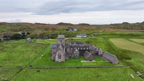 Aerial-View-of-Iona-Abbey-and-Nunnery,-Ancient-Landmark-in-Green-Landscape-of-Scottish-Island-UK
