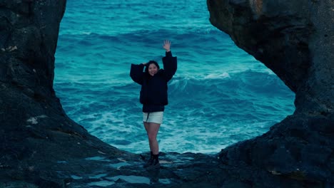 Asiatic-tourist-woman-standing-on-Cleopatra-Beach-bay-located-on-lagoon-in-Marsa-Matrouh-Egypt