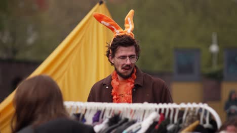 Close-up-of-Dutch-tourist-with-orange-rabbit-ears-celebrating-Dutch-Kingsday