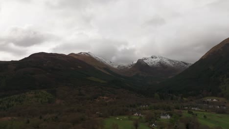 Slow-aerial-panning-shot-revealing-the-snowy-beinn-a-bheithir-in-Scotland