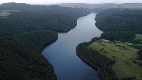 Aerial-view-of-Lake-Barrington-with-forest-and-rural-farm-property-near-Sheffield-in-Tasmania,-Australia