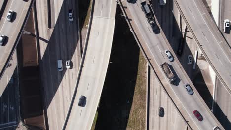 Birdseye-Aerial-View,-Traffic-on-Complexed-American-Highway-Junction-Interchange-on-Sunny-Day