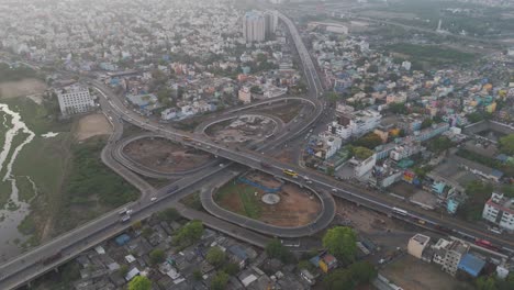 A-cinematic-drone-shot-of-Chennai,-highlighting-the-city's-bustling-activity-and-architectural-grandeur-under-a-cloudy-sky