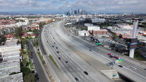 Landscape-view-of-Los-Angeles-city-skyline---descending-aerial-over-110-Pasadena-freeway