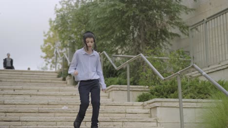 jewish-boy-running-down-stairs-in-the-street