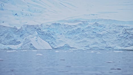Blue-Glacier-Ice-Close-Up-Detail,-Antarctica-Landscape-Scenery-with-Sea-Ice-and-Ocean-in-Beautiful-Antarctic-Peninsula-Cold-Blue-Winter-Scene-Showing-Crevasses,-Glacier-Melting-with-Global-Warming
