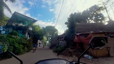 The-Philippines---Motorbike-ride-through-Coron's-quaint-alleyways,-capturing-the-island's-charm-and-adventure