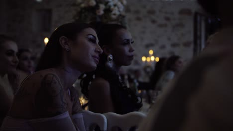 Slow-motion-shot-of-wedding-guests-listening-to-the-speeches-before-dinner