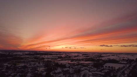 Aerial-footage-of-a-beautiful-snowy-winter-sunset-in-the-small-town-of-Lititz-PA-going-forward