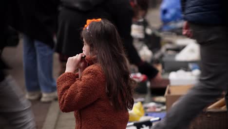 Cute-girl-playing-music-instrument-during-Netherlands-Koningsdag-celebration