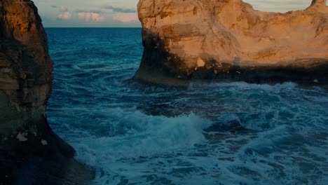 Waves-crushing-on-beach-rocks-in-Cleopatra-bath-Beach,-a-wonderful-bay-located-on-the-opposite-side-of-the-biggest-lagoon-in-Marsa-Matrouh