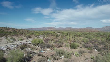 Dumped-Garbage-Littered-the-Road-in-the-Desert-Terrain-of-Mulege,-Baja-California-Sur,-Mexico---Aerial-Drone-Shot