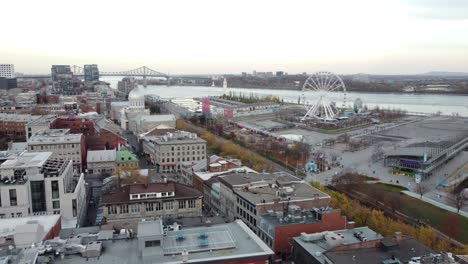 Aerial-view-of-the-Old-Port-of-Montreal,-drone-fly-above-Saint-Lawrence-River-at-sunset