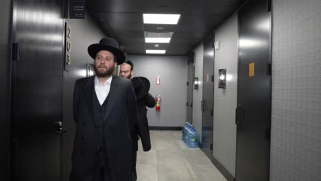 Two-Jewish-businessman-walking-in-a-corridor