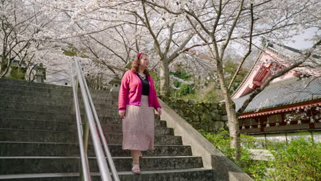 Woman-Looking-Around-The-Scenery-While-Going-Down-The-Stairs-In-Tsubosaka-dera-Temple,-Japan