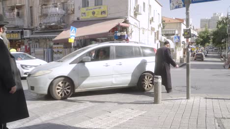 Hasidic-Jewish-people-walking-in-the-street-in-Jerusalem,-Israel