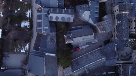 Aerial-top-view-of-Anciles,-showcasing-its-iconic-Pyrenean-architecture-at-dusk,-Spain