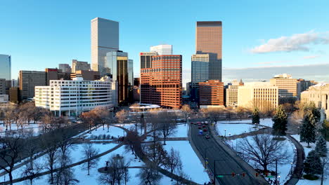 Snowy-winter-sunset-drone-view-over-Lincoln-Veterans-Memorial-Park-of-Denver-CBD
