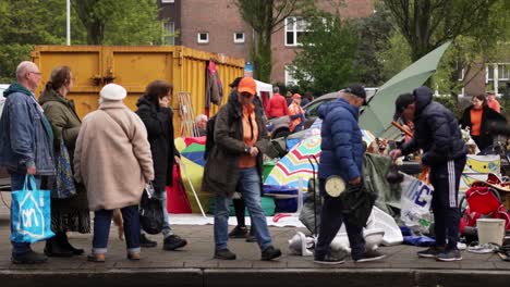 People,-umbrella's-and-items-exposed-during-Dutch-national-holiday-Koningsdag