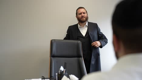 two-Jewish-businessmen-sitting-down-to-a-business-meeting