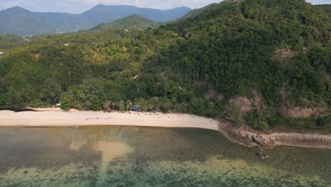 Stunning-drone-reveal-of-tropical-island-from-beach