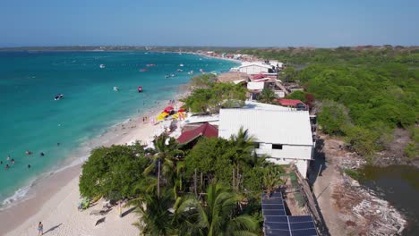 Playa-Blanca,-Cartagena-Colombia,-Revealing-Drone-Shot-of-White-Beach-Sand,-Landscape-and-People