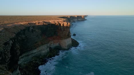 Aerial-pan-shot-of-Nullarbor-Cliffs-beside-an-ocean-in-South-Australia