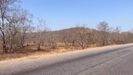 driving-along-asphalted-road-in-Wulugu-village,-Northern-Ghana