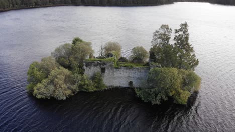 Aerial-View-Of-Ruins-Of-Loch-an-Eilein-Castle-In-Lake-Surrounded-By-Rothiemurchus-Forest