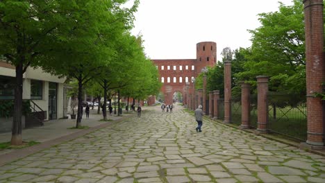 A-Roman-age-city-gate-in-the-Northern-Italian-city-of-Torino-,-the-magnificent-Porta-Palatina-makes-for-a-grand-entryway-into-Torino’s-city-centre