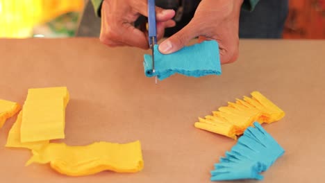 Cutting-paper-to-make-a-donkey-shaped-piñata