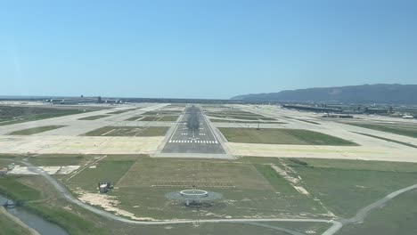 Real-time-landing-at-Barcelona-airport-shot-from-a-plane-cockpit-in-a-bright-spring-sunny-morning