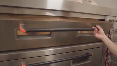 Commercial-bakery-oven-doors-opening-to-reveal-fresh-bread,-in-slow-motion