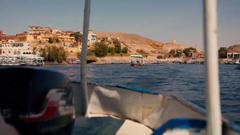 boat-view-of-Philae-temple-complex-island-in-Egypt-,-tourist-cruising-the-Aswan-Dam-and-Lake-Nasser-travel-destination-North-Africa