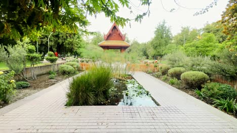 Santiago-de-Chile,-panoramic-trees,-green-gardens-of-Plaza-Tailandia-Thai-Park-inspirited-temple-architecture-background