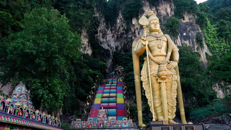 Murugan-Statue-With-Colorful-Staircase-To-Batu-Caves-In-The-Background