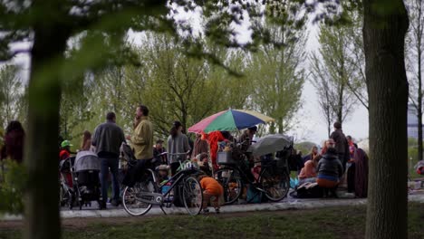 View-on-persons-picnicking,-chatting-and-celebrating-Dutch-Koningsdag-in-Amsterdam