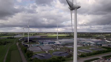 Closeup-of-wind-turbine-before-water-treatment,-bio-energy-facility-and-solar-panels-in-The-Netherlands