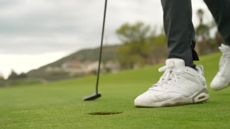 Recogiendo-La-Pelota-De-Golf-Del-Hoyo.