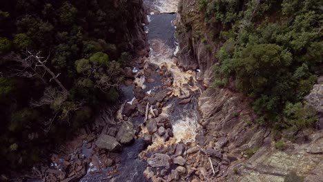 Top-shot-of-water-flowing-through-the-Leven-Canyon-in-Tasmania,-Australia