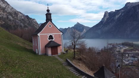 Cute-Church,-overlooking-Traunsee-lake-and-Ebensee-town-in-the-Salzkammergut-region,-Upper-Austria,-serene-mountain-backdrop