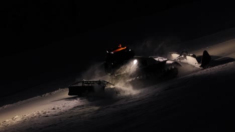 PistenBully-moves-over-snow-surface,-creating-even-surface-for-skiing