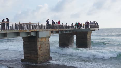 People-Admiring-The-View-on-Ocean-Peer,-Slow-Motion-Establishing,-Sri-Lanka