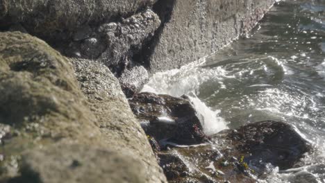 Slow-motion,-rocky-coastline,-incoming-tide,-ocean-water,-Ayrshire,-UK