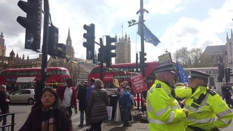 Two-police-officers-chatting-while-a-Pro-EU-group-is-protesting