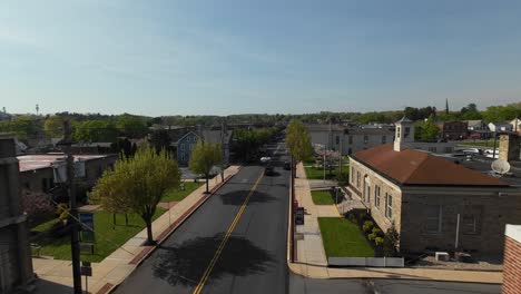 Slow-drone-flight-over-Elizabethtown-borough-in-Lancaster-County-with-historic-buildings-during-sunny-day,-USA