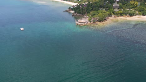 Cinematic-drone-reveal-over-luxury-beach-resort-on-island